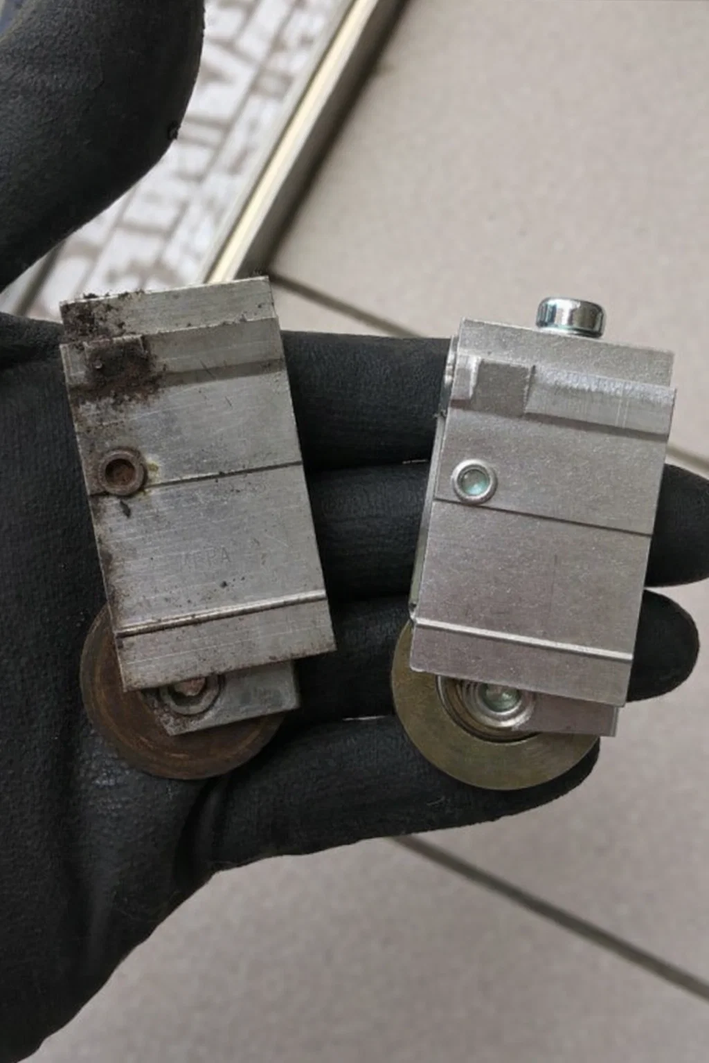 Sliding door repair technician working on a contemporary aluminum glass door